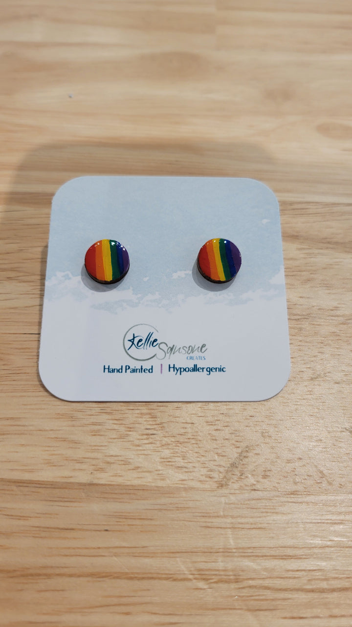 Circular handmade acrylic painted earrings with pride rainbow flag design by Kellie Sansone Creates