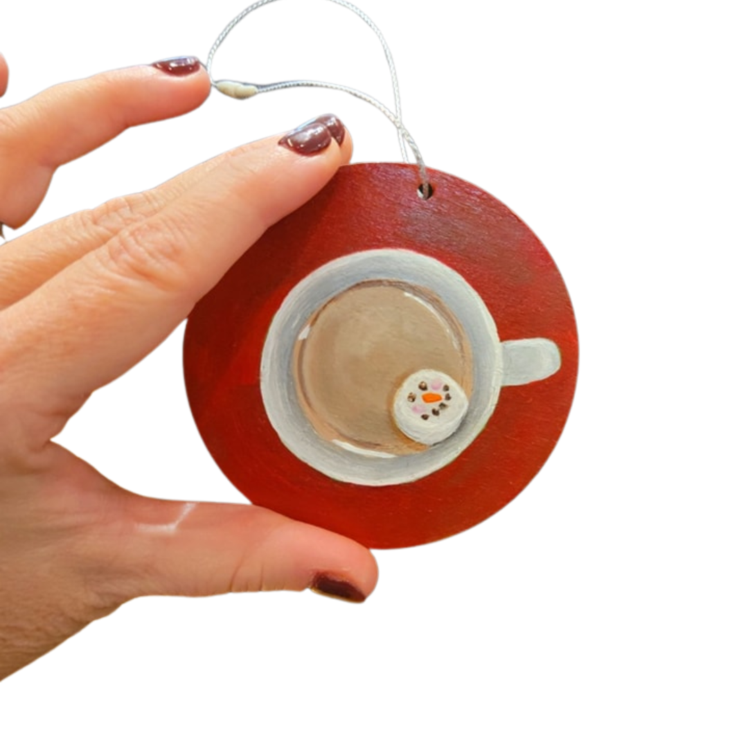 red circular ornament with top view of hot cocoa and snowman marshmallow